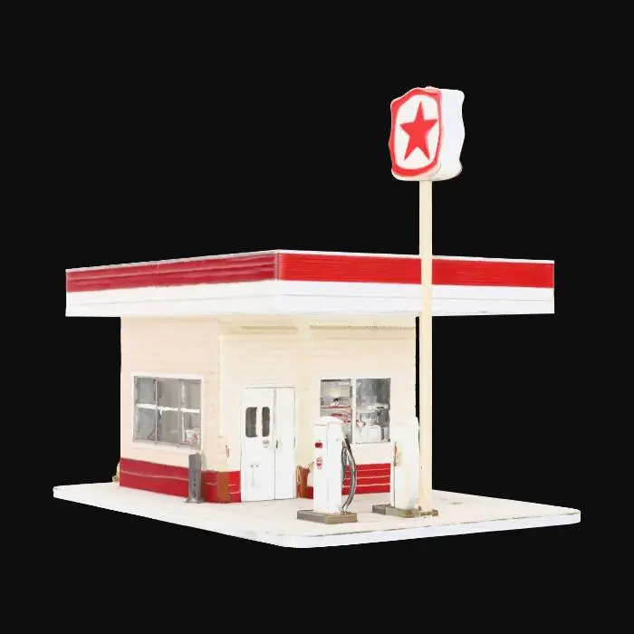 3D model for A detailed book nook featuring the miniaturized front of a retro gas station. The compact structure includes a cream-colored building facade with clear windows and a small entrance door, all made from smooth, painted wood. A wide, flat canopy extends over two tiny, silver-toned metal fuel pumps. A tall, slender pole supports a vintage-style sign with red and white branding. The ground is a dark grey, subtly textured asphalt, and the entire piece appears clean and meticulously crafted.