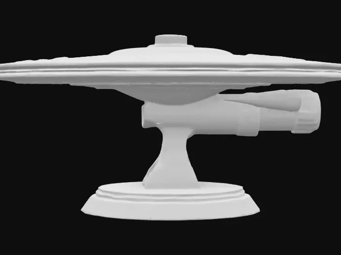 3D model for A 1 meter model of The USS Enterprise 1701A, tabletop miniature starship, Star Fleet Battles, game miniature, made of pewter and painted for Christmas. NVIDIA volumetric lighting, engine glow, on a gold wizkids heroclix base, deeply carved details. #ChristmasAdventure#