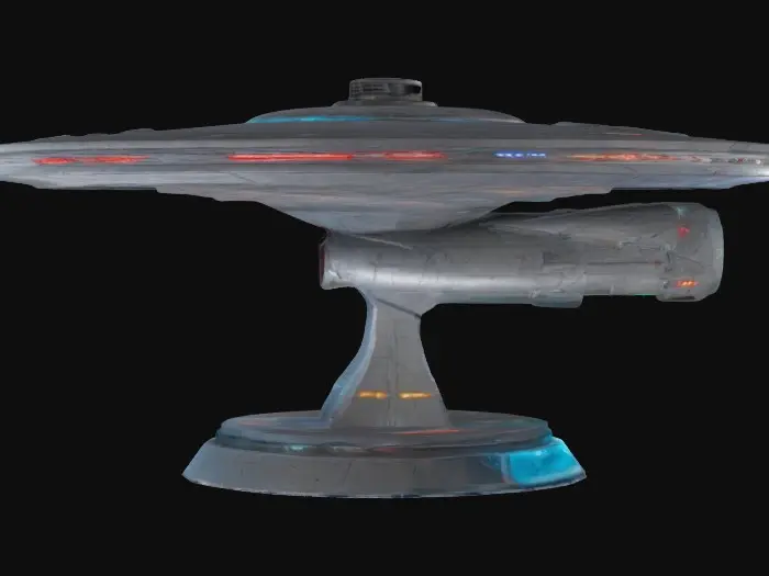 3D model for A 1 meter model of The USS Enterprise 1701A, tabletop miniature starship, Star Fleet Battles, game miniature, made of pewter and painted for Christmas. NVIDIA volumetric lighting, engine glow, on a gold wizkids heroclix base, deeply carved details. #ChristmasAdventure#