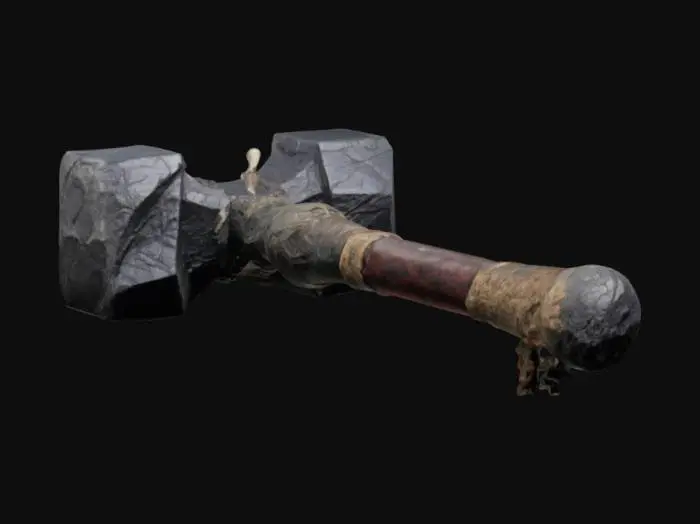 3D model for "A massive war maul crafted from a single piece of rugged granite, with a weathered surface and deep primitive carvings etched into the stone. The handle is wrapped in coarse animal hide for grip, showing signs of wear and age. The head of the maul is irregular yet balanced, featuring jagged edges and cracks from countless battles. Small bone trinkets and leather straps dangle from the handle, adding a tribal warrior aesthetic.", #ChronoForgeWeapon#