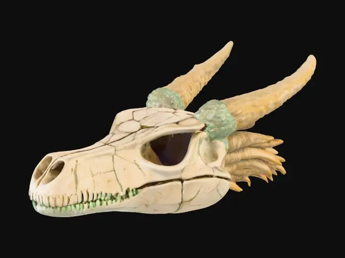 3D model for #PBR#, A fossilized dragon skull with elongated, ridged horns curving backward. The bone texture is weathered ivory with deep cracks and porous details, dusted with mossy green and earthen brown discoloration. Metallic deposits of tarnished copper streak through parts of the skull, giving it a mineral-encrusted look. The eye sockets glow faintly with ghostly turquoise light, casting a soft luminescence over the fractured bone surface.