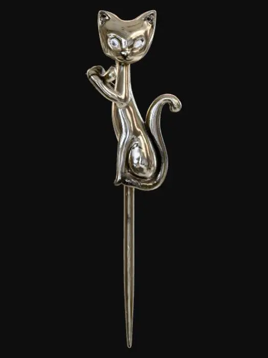 3D model for A delicate, polished metal hairpin, likely silver or gold-toned, featuring a smooth, curved shaft designed to hold hair. Perched prominently atop the pin is a small, intricately sculpted cat figure. The cat possesses a sleek, stylized form with pointed ears, a slender tail curled gracefully, and a subtly etched texture to suggest fur. Its eyes are small, dark beads, giving it a calm, alert expression. The overall piece feels solid yet lightweight.