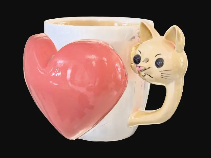3D model for Give me a coffee mug with a giant protruding heart on the side And a cat head as the handle on the mug
