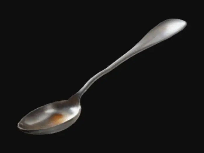3D model for A realistic silver spoon that has a scorch spot on it's bowl.