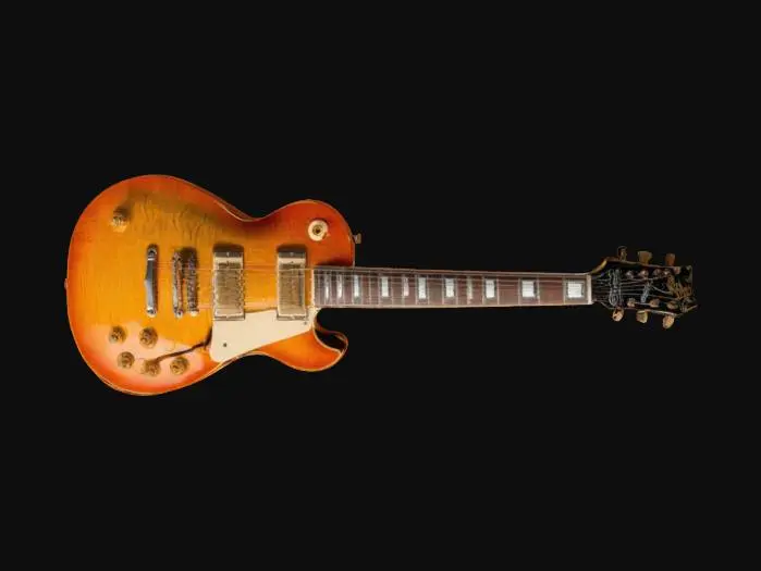 3D model for a vintage Gibson Les Paul guitar with a flame maple top. The body should feature a classic single-cutaway design with a sunburst finish, highlighting the wood's flame pattern. Include cream binding around the edges, vintage-style hardware, and two humbucker pickups with a selector switch. The neck should have pearl trapezoid inlays on a rosewood fretboard and vintage-style tuners on the headstock. Ensure realistic textures and materials, emphasizing the aged patina and fine wood grain