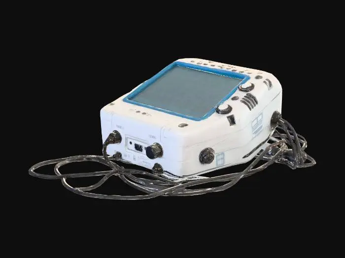 3D model for A game-ready, medium-polygon 3D model of a compact, portable medical device lying discarded on the floor, adhering to a realistic, gritty, and post-apocalyptic hospital aesthetic. It has a boxy, industrial design with a scratched and cracked light grey plastic casing. Attached black cables are tangled. Its small screen is dark, and buttons appear unresponsive, covered in dust.