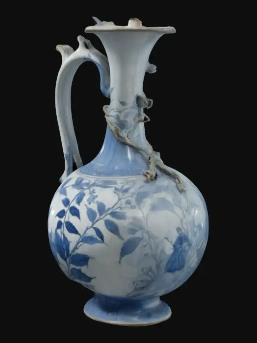 3D model for blue and white pomegranate shaped ewer with long thin spout with foliage attached. the six lobed body is decorated with two figures in landscape in pale silvery blue; on the neck a vine. borders of stiff leaves and vines. the base concave and glazed.