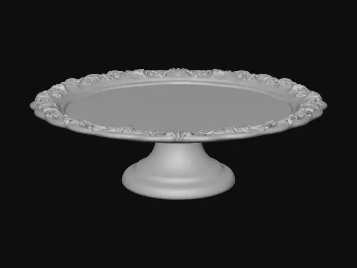 3D model for A classic European pedestal cake stand, white ceramic material, thick round plate with a slightly raised rim, delicate embossed floral and scroll patterns around the edge, smooth and clean plate surface, short and sturdy pedestal base with matching ornamental relief details, elegant and balanced proportions, French patisserie display style, fine glazed porcelain texture with soft reflections, pristine and flawless, single object, centered composition, isolated on pure black background, professional studio lighting, realistic shadows, photorealistic, ultra-detailed, 8K, commercial product photography