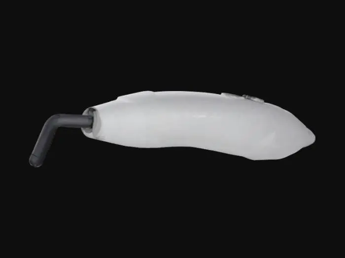 3D model for Design a sleek medical device using negative pressure to remove dead skin cells in burn care. The ergonomic handle is slightly curved with a textured, non-slip grip for comfort. A suction head at the tapered end applies controlled pressure to lift cells safely. Features include a recessed LED light near the suction head for illumination and a side button for easy control. The design is compact, with a clean white body, blue accents, and smooth, sterilizable surfaces for a professional look.