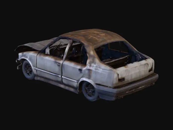 3D model for A heavily charred car wreck, its metallic frame twisted and contorted, revealing exposed structural beams. The blackened surface is covered in thick soot and ash, with remnants of melted plastic adhering to the warped chassis. Sections of glass are shattered, and tires are completely incinerated, leaving a desolate, gritty texture. The overall shape is collapsed and misshapen, conveying immense damage.