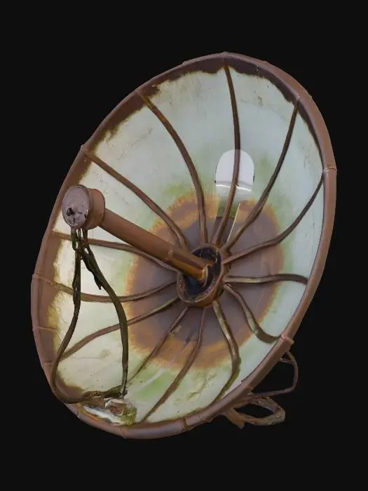 3D model for A heavily weathered, industrial-style parabolic dish, likely a spotlight or antenna, showing severe signs of age. Its large, concave metal reflector is covered in extensive rust and dark brown corrosion, with patches of dull green moss or grime adhering to its surface. A central cylindrical emitter protrudes from the dish. It is supported by an exposed, rust-covered metal frame and thick, coiled wires extending from the back. The material feels rough, gritty, and cold to the touch, with a brittle, peeling texture in places.