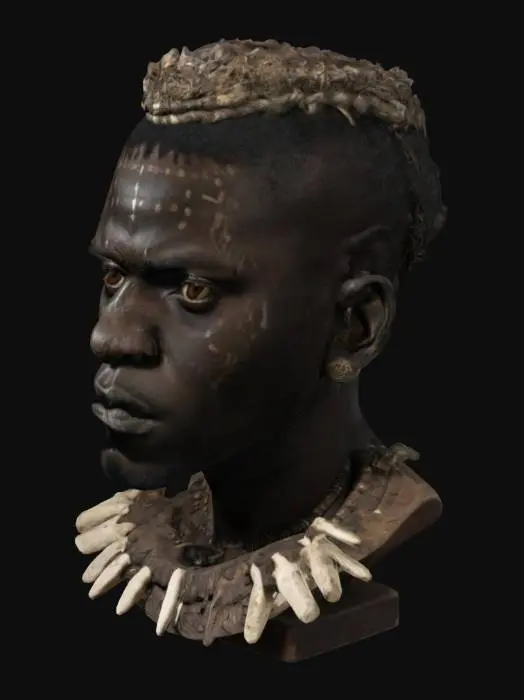 3D model for Busto realista de un hombre africano y negro con cara seria y agresiva y adornos tribales africanos relacionados al adinkra, huesos, colmillos, etc.