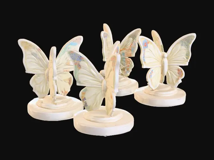 3D model for Three identical, beautifully colored ceramic butterflies, embossed and evenly spaced, and equal height stand wing to wing forming one circular pedestal on a round ceramic base. Vibrant, detailed, and intricate design reminiscent of the ornate designs of Alphonse Mucha and William Morris suitable to be used as an orb stand.
