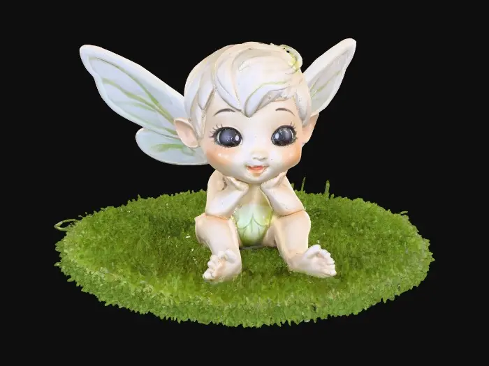 3D model for Ceramic figurine of a Chibi child like snowdrop fairy. Perfect facial features with well formed arms, hands, legs, & feet. Well defined wings. Fairy is sitting on a round patch of grass.