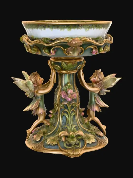 3D model for A pedestal comprised of small fairies that are holding a bowl shapped base above their heads. The complete design is on a 3 inch round base. Victorian, Extravagant, elaborately embossed design. A masterpiece of art nouveau, lush botanicals are interwoven into the design