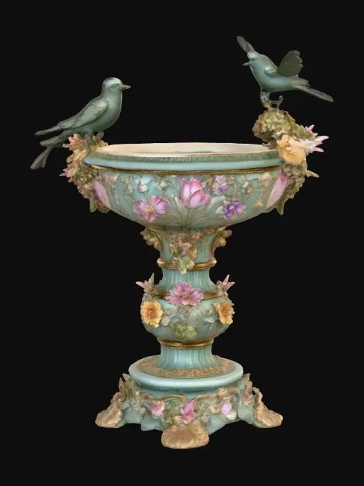 3D model for An elaborately designed pestal with a small bowl shapped base on top. The pedestal sits on a 3 inch base plate. The entire design is a masterpiece of art comprised of lush botanical, florals, cherubs and birds. Elements of Rocco, art nuevo era. Colors representing the victorian era.