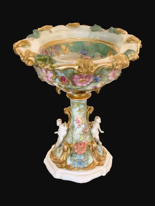 3D model for An elaborately designed pestal with a small bowl shapped base on top. The pedestal sits on a 3 inch base plate. The entire design is a masterpiece of art comprised of lush botanical, florals, cherubs and birds. Elements of Rocco, art nuevo era. Colors representing the victorian era.