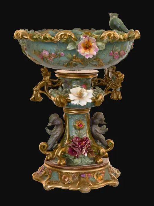 3D model for An elaborately designed pestal with a small bowl shapped base on top. The pedestal sits on a 3 inch base plate. The entire design is a masterpiece of art comprised of lush botanical, florals, cherubs and birds. Elements of Rocco, art nuevo era. Colors representing the victorian era.