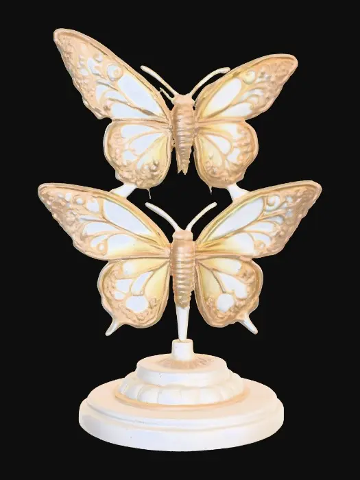 3D model for Three identical, beautifully colored ceramic butterflies, embossed and evenly spaced, and equal height stand wing to wing forming a circular pedestal on a round ceramic base. Vibrant, detailed, and intricate design reminiscent of the ornate designs of Alphonse Mucha and William Morris suitable to be used as an orb stand.