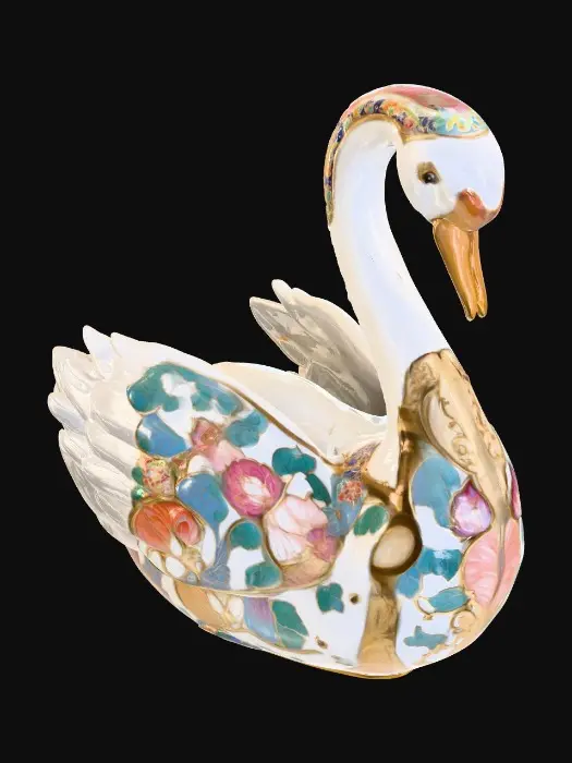 3D model for A delicate porcelain figurine displayed against a pristine, crisp white background, exuding elegance and refinement. At the center stands a thick, ornate etched porcelain arbor with intricate detailing and a glossy finish. Resting gracefully on the arbor’s base is a luxurious cloisonné swan, adorned with vibrant enamel patterns in rich jewel tones and fine gold accents, adding a touch of opulence to the composition. The highlighting enhances the textures and craftsmanship of each element while maintaining a serene, minimalist atmosphere.