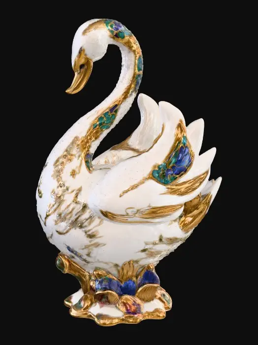 3D model for A delicate porcelain figurine displayed against a pristine, crisp white background, exuding elegance and refinement. At the center stands a thick, ornate etched porcelain arbor with intricate detailing and a glossy finish. Resting gracefully on the arbor’s base is a luxurious cloisonné swan, adorned with vibrant enamel patterns in rich jewel tones and fine gold accents, adding a touch of opulence to the composition. The highlighting enhances the textures and craftsmanship of each element while maintaining a serene, minimalist atmosphere.