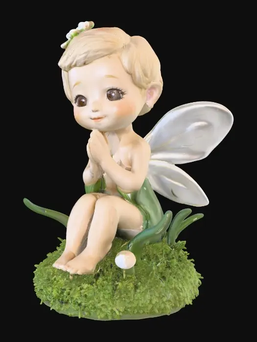 3D model for Ceramic figurine of a Chibi child like snowdrop fairy. Perfect facial features with well formed arms, hands, legs, & feet. Well defined wings. Fairy is sitting on a round patch of grass.