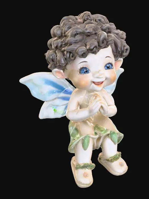 3D model for Ceramic figurine of a Chibi child like snowdrop fairy. Perfect facial features with well formed arms, hands, legs, & feet. Well defined wings. Fairy is sitting on a round patch of grass. Beautiful full wide smile laughing uncontrollably. Twinkling large blue eyes. Wild thick Curly hair
