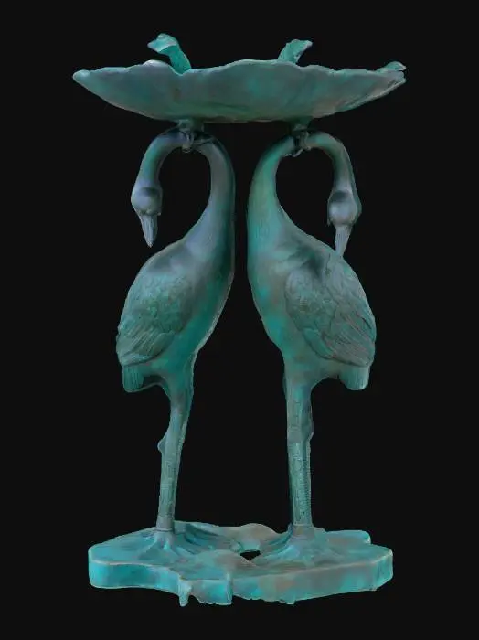 3D model for The object is a decorative bird bath with a round, leaf-shaped basin supported by intricately textured, standing crane figures with a patina finish., 