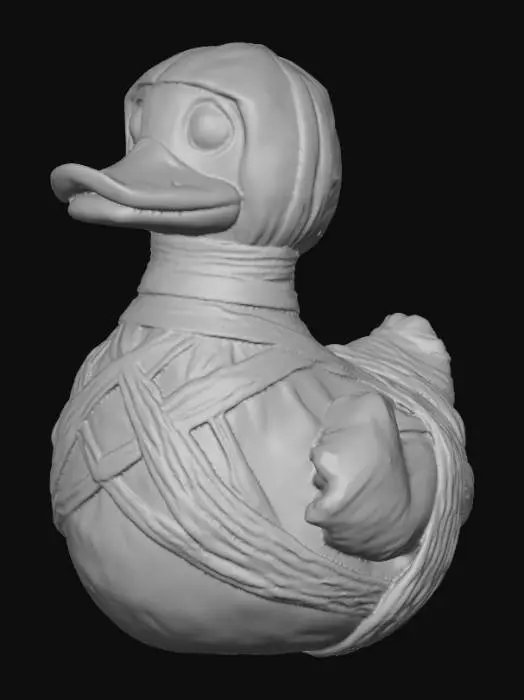 3D model for A menacing rubber duck, re-imagined as a mummified creature, features an aged, off-white surface with a dry, slightly crinkled texture. Its body is haphazardly wrapped in linen-like bandages, partially obscuring the familiar duck silhouette. Faint sepia-toned yellow plastic subtly shows through gaps in the wraps, hinting at its original form. The eyes are deeply recessed, appearing hollow and devoid of life, contributing to its eerie, ancient appearance.


  Optimized for 3d printing