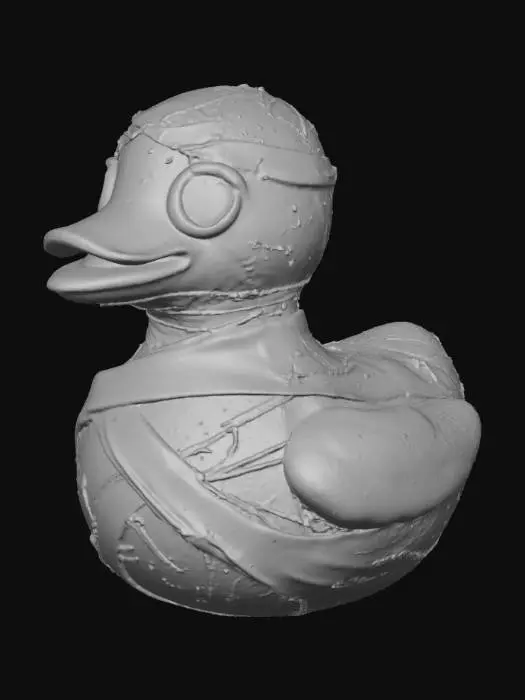 3D model for A menacing rubber duck, re-imagined as a mummified creature, features an aged, off-white surface with a dry, slightly crinkled texture. Its body is haphazardly wrapped in linen-like bandages, partially obscuring the familiar duck silhouette. Faint sepia-toned yellow plastic subtly shows through gaps in the wraps, hinting at its original form. The eyes are deeply recessed, appearing hollow and devoid of life, contributing to its eerie, ancient appearance.
optimized for 3d printing