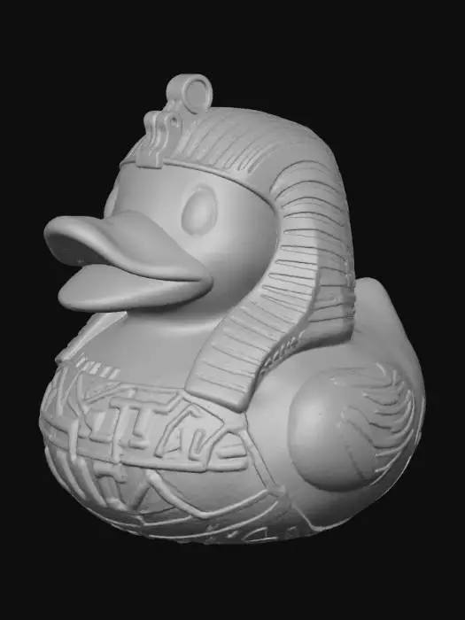 3D model for A dark, mummified Pharaoh rubber duck, solid 3D model for printing. The classic rounded duck body is gaunt and wrapped in aged, tattered linen bandages with rough texture and uneven layers. Beneath the wraps, faded yellow plastic shows through in worn patches. The duck wears a weathered Egyptian Nemes headdress, partially torn, with a short, cracked ceremonial beard extending from its beak. Deep, shadowed eye sockets give it a lifeless, haunting stare. Its chest bears faint, eroded hieroglyphic carvings and embossed ankhs, barely visible beneath the wrappings. The form is bold and compact, with watertight geometry, no thin parts, and subtle surface wear that suggests ancient decay.