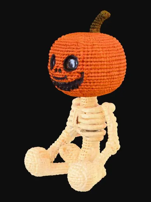 3D model for A cozy, handcrafted 3D Halloween skeleton with a pumpkin head, designed in the style of a knitted or crocheted amigurumi toy. The pumpkin head has a friendly yet spooky carved face, with visible yarn fibers, soft wool texture, and small handmade imperfections. The cream-colored skeleton body is fully crocheted, with detailed loops and interwoven strands. The character is sitting — either cross-legged or with legs outstretched — in a relaxed, cute pose. Base should be flat and stable for sitting on a shelf.  The overall style is warm, whimsical, and slightly eerie, like a handmade Halloween collectible. Optimized for 3D printing.