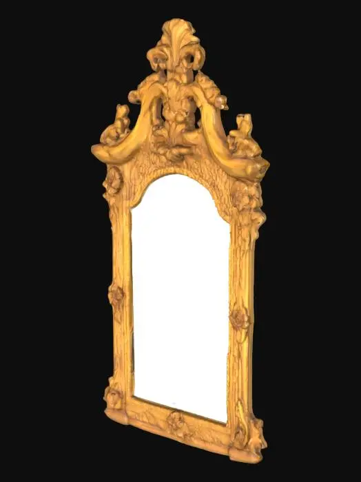3D model for A charming little 18th century regency boudoir style mirror, in gilded and carved wood, with an ornate pediment featuring a trio of flowers protruding from a latticework background. The carved decoration is continued around the frame on all four sides, with the whole piece nicely aged and full of character. There is a small area of damage to the front, as might be expected for a piece of this age.  37,5 × 61,5 cm