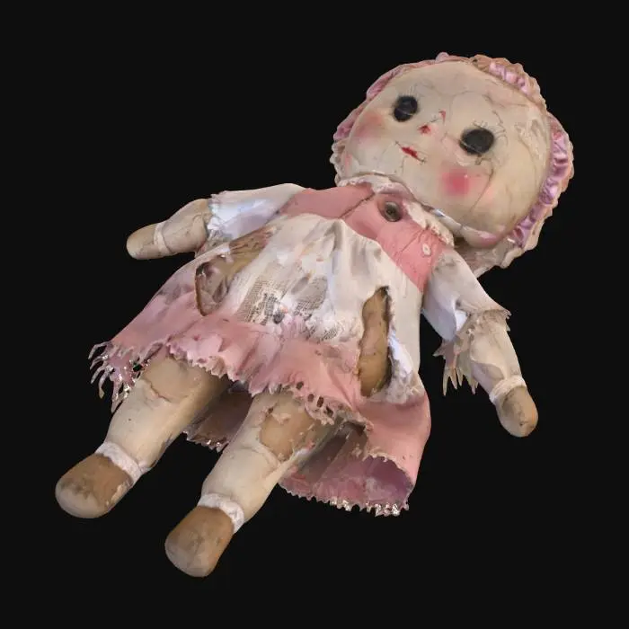 3D model for A 3D model of a small child’s ragdoll toy, lying discarded on the ground.  
The doll should look old, worn out, and slightly creepy.  
Details: one button eye missing, seams ripped open with stuffing coming out, faded fabric with dirty stains, torn dress with frayed edges, limp arms and legs in an unnatural position as if thrown aside.  
Scale: small toy size (around 30 cm).  
Style: realistic PBR textures (fabric, stitching, dirt).  
Use muted pastel colors (light pink, pale blue, beige) but heavily worn and dirty.  
Position: lying sideways on the ground, not standing upright.  
