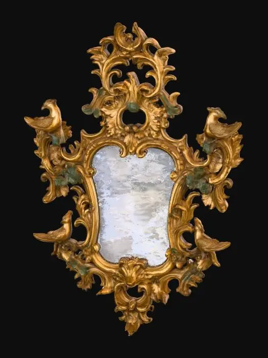 3D model for An ornate, antique gilded mirror featuring a rococo style frame. The frame is crafted from aged, slightly distressed wood, textured with intricate carvings of scrolling acanthus leaves and flourishes, exhibiting a rich, dull gold finish with hints of darker patina in the crevices. Four distinct, finely detailed bird figures with textured feathers are perched symmetrically on the upper and lower sides of the irregularly shaped, reflective glass pane, adding to its elaborate, sculptural appearance.