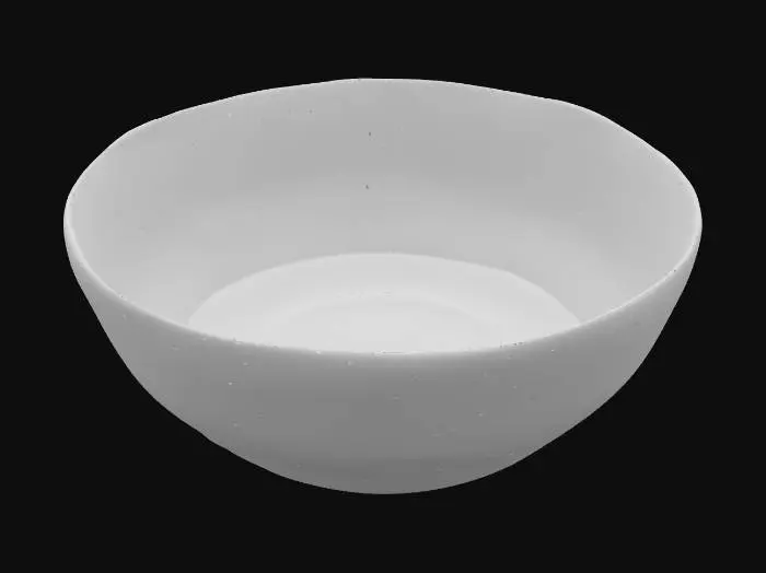 3D model for A contemporary porcelain serving plate with a wide, flat rim and a shallow, irregular basin, finished in a striking deep indigo blue glaze. The surface is exceptionally smooth and cool to the touch, reflecting ambient light with a profound, mirror-like gloss. Subtle, almost imperceptible raised geometric patterns provide a delicate texture, giving the plate a modern, sophisticated PBR appearance.