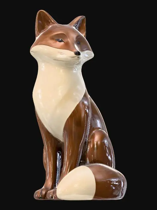 3D model for A minimalistic glossy ceramic sculpture of a sitting fox, stylized body with soft edges, polished glaze in chestnut brown and creamy beige, highly reflective glossy finish, modern decorative aesthetic, cinematic render, dark gradient background.
