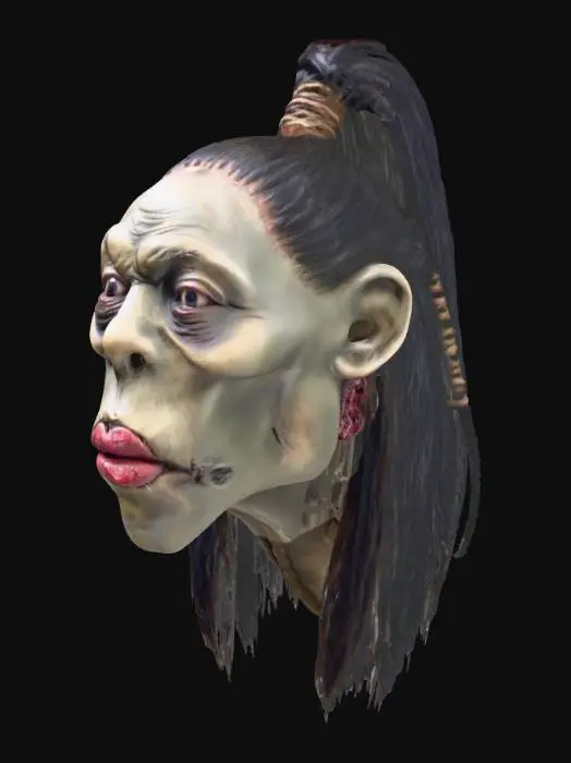 3D model for amazon shrunken head with lips sewn shut, hair is pulled up and back in ponytail
