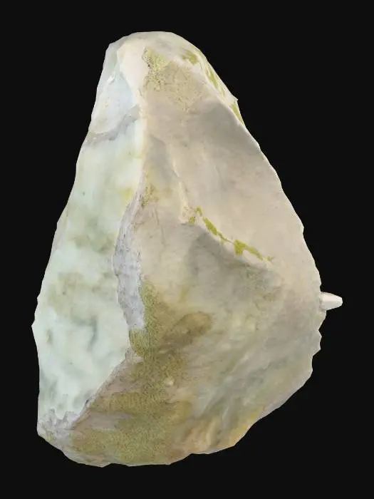 3D model for A rough, irregular stone, primarily composed of a granular mineral matrix. Its surface displays a varied texture, ranging from smooth, water-worn patches to jagged, sharp edges and crevices. The color is a muted gray, with hints of earthy browns and subtle greenish moss clinging to some depressions. Its overall shape is amorphous, a heavy, solid mass, cool and hard to the touch, with small embedded flecks of crystalline material.
