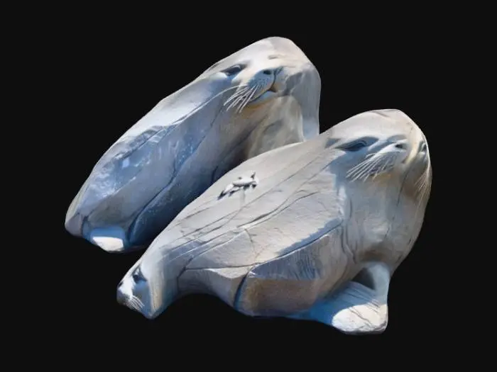 3D model for small piles of grey rocks craved as sealions with a single eye, craved as single blinded eyes, or patterned birds without faces,