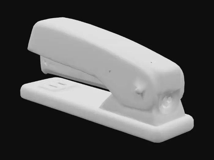 3D model for A classic, iconic Swingline stapler, distinguished by its vibrant, matte red finish that coats a durable metal body. It features an elongated, rectangular base with a smoothly curved, hinged top arm, and a black, tactile plastic component at its rear. The surface is predominantly smooth with a slight sheen on the painted metal, offering a solid, satisfyingly weighty feel in hand, indicative of its robust construction.