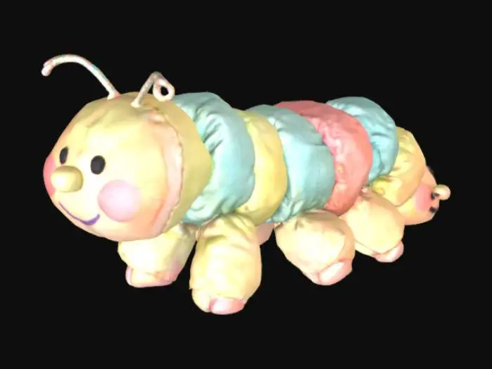 3D model for A stuffed caterpillar toy with segmented body and mismatched colors. Each segment has a tiny smiling face, but one face has no mouth. Pastel colors, slightly dirty, stitched seams exposed.

