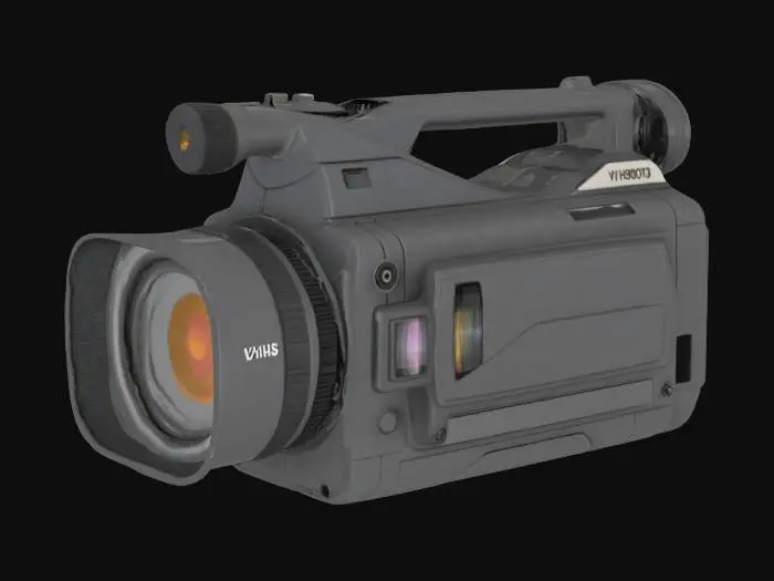 3D model for A highly detailed, realistic 3D model of a vintage shoulder-mounted VHS camcorder from the late 1980s. The body is robust and blocky, made of dark gray, textured hard plastic. On the front, a prominent zoom lens with a manual focus ring and a rubber lens hood. On the side, a mechanical cassette compartment with a clearly labeled 'EJECT' button. Include a large red 'REC' button, a 'W/T' zoom rocker switch, and a full set of VCR-style transport controls (PLAY, PAUSE, REW, FF, STOP). It has a black rubber eyepiece viewfinder extending from the back and a padded shoulder rest. The overall model should have a realistic, slightly worn, analog-era aesthetic. Realistic. Hard surface. High defined texture. Daylight.