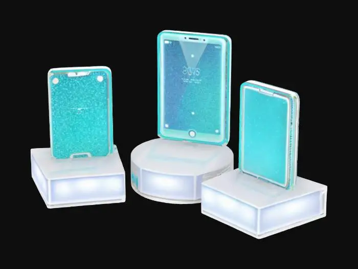 3D model for Object: Showcase stands with glitter-finish phones and tablets  
Material: Glossy plastic shells, LED base lights  
Shape/Form: Small angled pedestal stands with plugged-in devices  
Color Scheme: Electric blue screens, teal casings, neon glow  
Texture Details: Glitter sparkles, glowing edge panels  
Style: Glam tech showroom  
Environment/Use Context: Demo area for digital accessories

