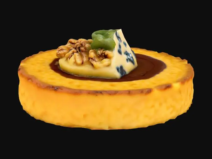 3D model for A small polenta round, pan-fried to a crisp edge with a golden, grainy surface, holds a dab of creamy blue cheese (pale with light blue veining). Topped with a toasted walnut half—wrinkled, matte tan—and a drizzle of thick balsamic glaze, almost black and glossy.

