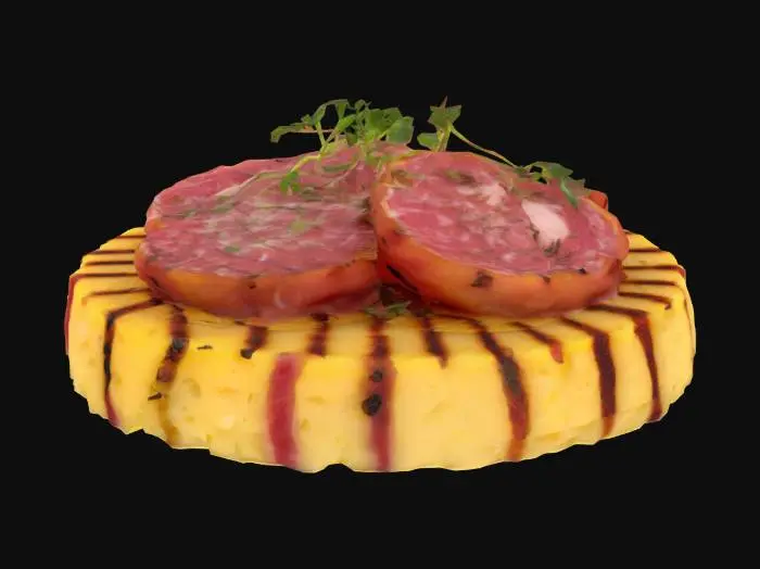 3D model for A small round of grilled polenta—light yellow with crisp browned ridges—topped with a thin slice of Cinta Senese salami (mottled pink-red with white fat marbling). Garnished with a cracked pepper edge and micro fennel greens.