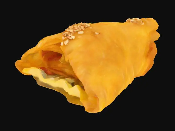 3D model for A small, crisp triangle of fried phyllo pastry—golden and flaky, with visible layering—filled with sweet almond paste scented with orange blossom water. The outside is lightly brushed with honey glaze and sprinkled with toasted sesame seeds.