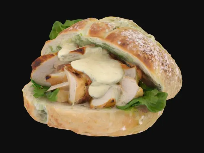 3D model for A mini ciabatta roll slice—crusty and flour-dusted exterior with an open, soft crumb. Filled with sliced grilled chicken breast (moist, white with grill marks), a smear of Caesar dressing (creamy off-white), and a crisp romaine lettuce leaf.