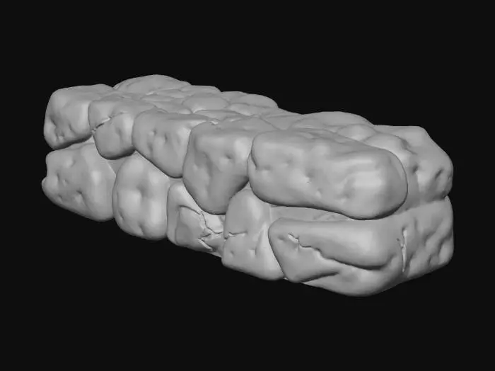 3D model for Płotek/murek zbudowany z kamieni poukładanych jeden na drugim, tworząc niską, nieregularną barierę. Kamienie mają różnorodne kształty i rozmiary, z chropowatą, naturalną teksturą, z widocznymi pęknięciami i nierównościami. Kolory to odcienie szarości, brązu i zieleni mchu, o chłodnym, kamiennym dotyku. Konstrukcja jest prosta, ale solidna i organiczna w formie.