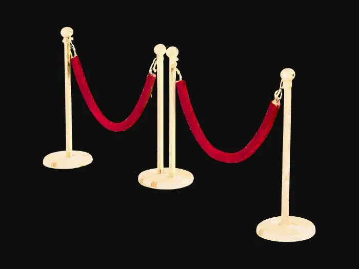 3D model for Two elegant red rope stanchions stand symmetrically, each featuring a slender, polished gold or chrome-plated metal post firmly anchored to a wide, weighted circular base. The posts exhibit a smooth, highly reflective surface. Between them, a vibrant, plush red velvet rope sags gracefully, forming a gentle U-shape. The rope, thick and soft to the touch, has a subtle nap, and its ends are capped with sturdy, ornate gold or chrome clasps that securely hook onto the top of each post, completing the luxurious barrier.